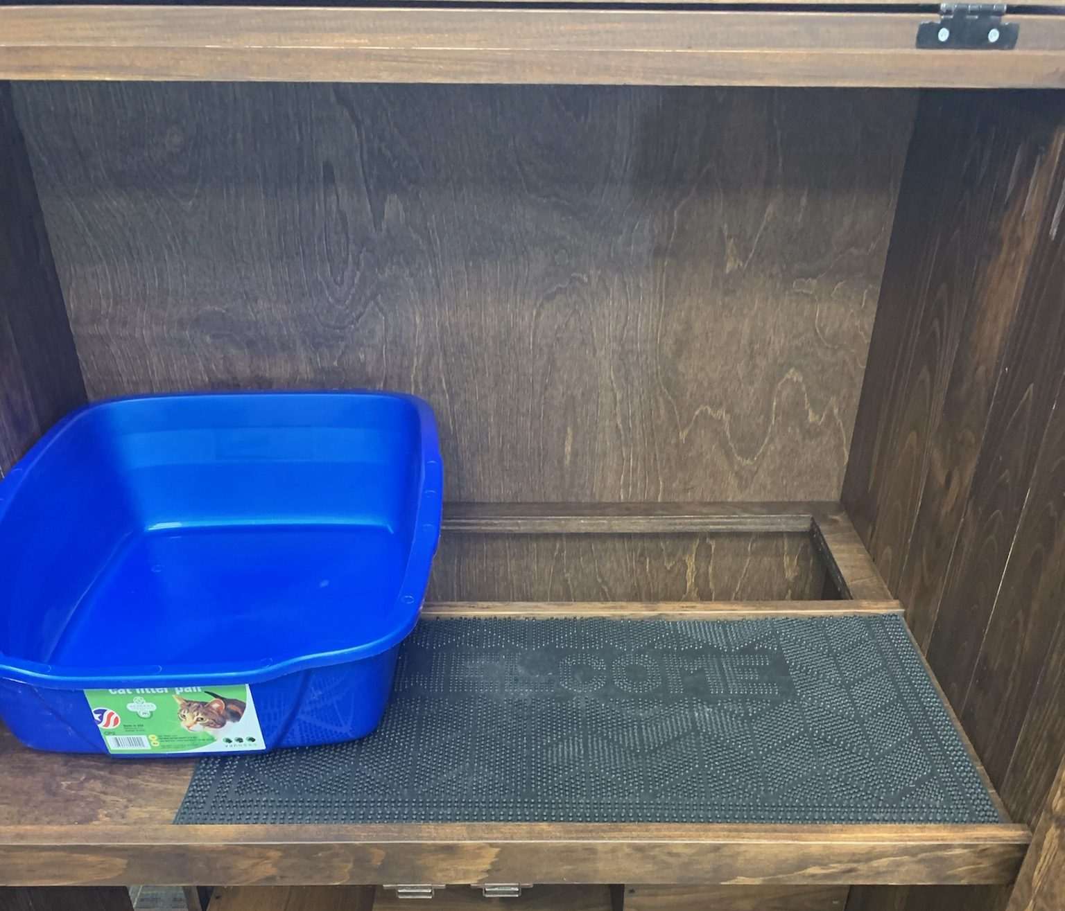 view of litter box and mat in the cat cache